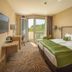 Greenfield Hotel Golf & Spa, Bük room with king bed, balcony door, and golf course view