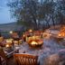 Tshukudu Bush Lodge in Pilanesberg fire pit lounge with curved stone seating and lantern lighting