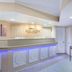 Baymont Inn & Suites Lake City lobby front desk with blue accent lighting and wall art