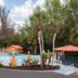 Baymont Inn & Suites Lake City outdoor pool area with palm trees and fenced deck