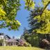 Milton Park Country House Hotel & Spa in Bowral, manor house exterior with lush gardens and blue sky
