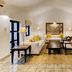 Habarana Village by Cinnamon in Habarana living room with white sofas, wood table, TV and tiled floor