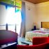 Ashley Resort in Nuwara Eliya guest room with double bed, balcony doors, and red chair