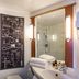 ibis Cannes Mouans-Sartoux bathroom with glass shower and vanity mirror in Mouans-Sartoux