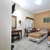 Hotel Mataram Malioboro Yogyakarta room with two single beds, desk, chair, mirror and TV in Yogyakarta