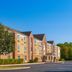 Candlewood Suites Indianapolis - South By IHG in Greenwood, exterior of brick hotel with clear blue sky