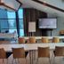 Power Park Accommodation in Kauhava meeting room with conference tables, chairs, and TV screen