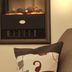 Appartement Sonnengarten in Ramsau am Dachstein with a wall-mounted electric fireplace and sofa pillow