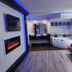 Motel 6 Little Rock North in North Little Rock: modern suite with red sofa, whirlpool tub and wall fireplace