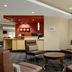 TownePlace Suites by Marriott Williamsport lobby seating area with lounge chairs and workstations