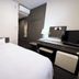 Hotel Route-Inn Court Kashiwazaki room with bed, desk, TV and air conditioner in Kashiwazaki