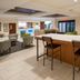 Holiday Inn Express & Suites Biloxi-Ocean Springs lobby with bar seating and lounge area