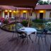 Agriturismo Cascina Madonnina in Arluno: outdoor terrace with tables, chairs and pond at dusk