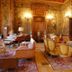 B&B Chateau de Villersexel in Villersexel: ornate salon with fireplace, piano, and antique seating