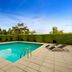 Quest Narre Warren pool with sun loungers and hedge-lined patio in Narre Warren