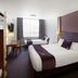 Premier Inn Huddersfield Central room with two beds, desk and window in Huddersfield
