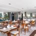 Citi Hotel Express Caruaru breakfast area with tables, chairs, and buffet counter in Caruaru