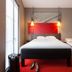 ibis Rueil-Malmaison Centre guest room with double bed, twin bed, and red rug in Rueil-Malmaison