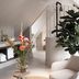 Hotel Abdij Dokkum attic suite with spiral staircase, white bed, and lounge chair in Dokkum