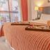 Duomi Hotel Buenos Aires room with a bed, breakfast tray, and balcony view in Buenos Aires