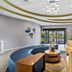 Holiday Inn Express & Suites Lakeland South lobby with curved blue and yellow seating and chandelier