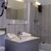 Bathroom at Logis Hôtel Restaurant Auberge Saint Martin in Saint-Gatien-des-Bois with shower, sink, and mirror
