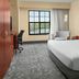Courtyard by Marriott Aberdeen at Ripken Stadium guest room with king bed, desk, and large window