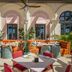 The Phoenicia Malta in Valletta: outdoor terrace with orange seating, tables, and arched windows