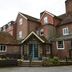 Chequers Inn by Greene King Inns in Uckfield, brick hotel entrance with blue doors and welcome sign