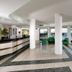 Park Hotel Mirabeau lobby with green chairs and sea-view glass doors in Gasperina