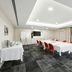 Quest Narre Warren meeting room in Narre Warren with conference table, red chairs, and projector screen