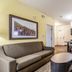 Candlewood Suites Portland-Airport By IHG in Portland: suite living area with sofa, chair, kitchenette and table