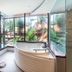 Royal Phawadee Village Patong bathroom with corner soaking tub and tropical garden views