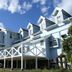 Yugawara Bay Mandarin House in Yugawara with a light blue multi-story exterior and mountain backdrop