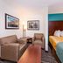 Sunset Motel Hood River guest room with sofa, chairs, and bed in Hood River