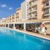 Globales Playa Santa Ponsa in Santa Ponsa: outdoor pool beside resort buildings and lounge seating