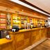 Premier Inn Huddersfield Central bar area with wooden counter and illuminated back bar in Huddersfield