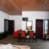 Ashley Resort in Nuwara Eliya room with dining table, wood ceiling, and large windows with mountain view