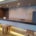 Hotel Route-Inn Gifukencho Minami lobby front desk in Gifu with wood stools and warm lighting