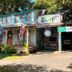 Blue Moon Guest House in Lafayette, rustic two-story inn with porch, balcony and lush greenery