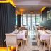 New Hotel Kuc by Marvel in Sveti Stefan dining room with set tables and large windows