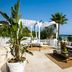 Canne Bianche Lifestyle Hotel in Torre Canne with ocean-view terrace, daybed, sofa and palm trees