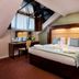 Treacy's Hotel Enniscorthy room with skylight, desk, and king bed with upholstered headboard