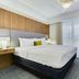 Homewood Suites by Hilton Louisville-East bedroom with king bed, wood accent wall, and large window
