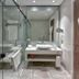 Arjaan by Rotana - Dubai Media City bathroom with glass shower, double vanity and bathrobes