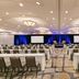 Hilton Scottsdale Resort & Villas meeting room in Scottsdale with rows of tables, chairs, and stage screens