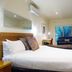The Wyndhamere Motel Shepparton guest room with king bed, sofa, desk and large window view.