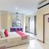 OYO 1134 Baan Zarn Guesthouse Patong room with bed, sofa, wall art and bright window