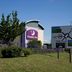 Premier Inn Thurrock West in West Thurrock, exterior with sign, trees and roadside direction signs