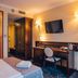 Hotel Admiral, Gdansk guest room with bed, desk, chair, wardrobe and wall-mounted TV